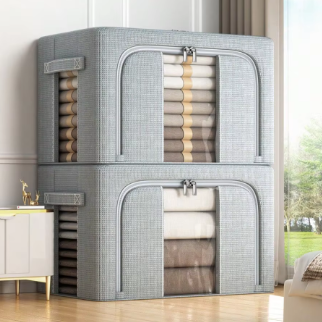 Gray foldable storage box for blankets, quilts, and seasonal bedding.